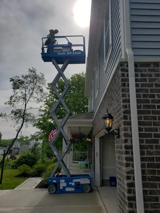 A lift moves the 50-pound panels to his roof.
